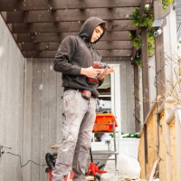 a young construction worker outside of a residential house working - home decoration stock pictures, royalty-free photos & images