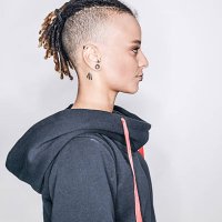 a young mixed race woman posing in a studio in profile - hairstyle stockfoto's en -beelden