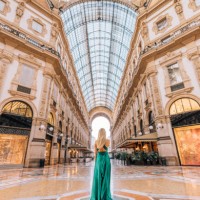 a young tourist woman in a green long dress walking, shopping and standing in the galleria vittorio emanuele ii in milan, italy, offers a stunning view of the golden gate to luxury shopping - fashion stock pictures, royalty-f