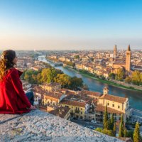 a young woman admires the view of verona old town from castel san pietro - travel stock pictures, royalty-free photos & images