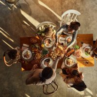 above view of black extended family having lunch at dining table. - food stock pictures, royalty-free photos & images