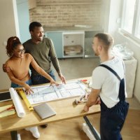 above view of happy black couple talking about plans with their manual worker. - home decoration stock pictures, royalty-free photos & images