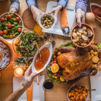 above view of passing food during thanksgiving dinner. - food stock pictures, royalty-free photos & images