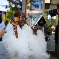 Achieng Agutu poses with her Prada make up kit and beauty blender outside the Pat Bo show during the New York Fashion week Spring/Summer 2025 on...