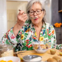 active senior woman is enjoying her healthy breakfast - food stock pictures, royalty-free photos & images
