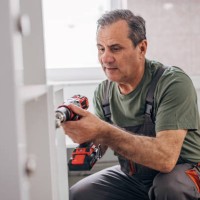 active senior works, installs the furniture - home decoration stock pictures, royalty-free photos & images