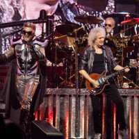Adam Lambert, Brian May and Roger Taylor of Queen + Adam Lambert perform at Little Caesars Arena on October 10, 2023 in Detroit, Michigan.