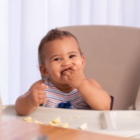 adorable baby eating food by himself. - food stock pictures, royalty-free photos & images