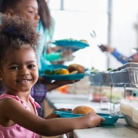 adorable little girl in soup kitchen - food stock pictures, royalty-free photos & images