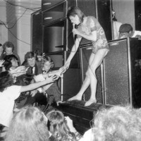 Adoring fans reaching out to touch the hand of the English pop star, David Bowie, during the concert at the Hammersmith Odeon where Bowie announced...