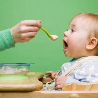adult feeding baby - food stock pictures, royalty-free photos & images