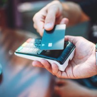adult man paying with credit card at cafe, close-up of hands with credit card and credit card reader - food stock pictures, royalty-free photos & images