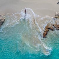 aerial view of a woman walking out of the water_little exuma_exuma_bahamas - travel photos et images de collection