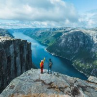 aerial view of man and woman raising holding arms in mountains in norway - travel stock pictures, royalty-free photos & images