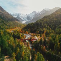 aerial view of train passing pristine landscape of piz bernina in swiss alps - travel stock pictures, royalty-free photos & images