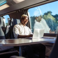 african american businessman working on laptop at the train - travel stock pictures, royalty-free photos & images