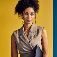 african american businesswoman looking at the camera. indoor casual portrait with yellow, blue, and white background. professional and confident concept. - fashion stock pictures, royalty-free photos & images