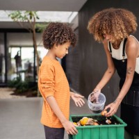african american young woman and her younger brother making compost from leftovers. sustainability concept. - food stock pictures, royalty-free photos & images