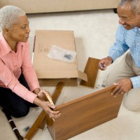 african couple assembling shelf - home decoration stock pictures, royalty-free photos & images