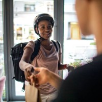 african delivery woman delivering package to customer - junk food stock pictures, royalty-free photos & images