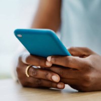 african woman using a cellphone in an office alone - home decoration stock pictures, royalty-free photos & images