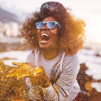 afro hipster girl laughing ecstatically while throwing gold glitter - fashion stock pictures, royalty-free photos & images