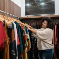 afro woman buying clothes - fashion stock pictures, royalty-free photos & images