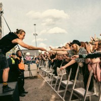Aki Hakala of The Rasmus hands drumstick to a fan at Jarvenpaa Soi Festival 2022 on August 8, 2022 in Jarvenpaa, Finland.