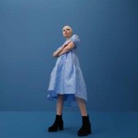 albino woman with arms crossed against blue background - fashion stock pictures, royalty-free photos & images
