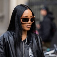 Aleali May wears black leather jacket, shirt with print outside 032C during the Menswear Fall Winter 2025/2026 as part of Paris Fashion Week on...