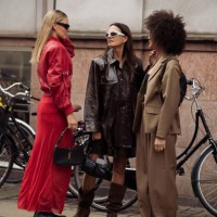 Alessa Winter wears red long skirt, red leather jacket, black shoes and black bag and Anna Winter wears long brown boots, brown leather skirt,...