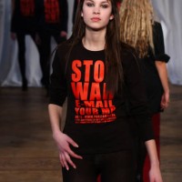Alexa Chung wears a creation by designer Katharine Hamnett during her autumn/winter 2003 collection catwalk show as part of London Fashion Week at...