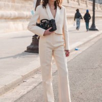 Alexa Chung wears cream suit, Dior bag, black Dior loafers, black sunglasses, outside Dior, during the Womenswear Fall/Winter 2024/2025 as part of...