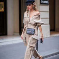 Alexandra Lapp is seen wearing a beige Frankie Shop jumpsuit, Chanel earrings, vintage Chanel classic bag, Chanel ballerinas, Chanel baker boy cap...