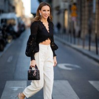 Alexandra Lapp is seen wearing a Corsage Embellished Bodice in black from Zimmermann, black and white striped high-waist 7/8 length pants from Chloé,...