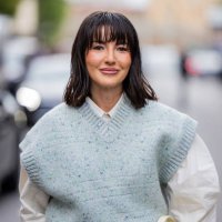Alexandra Pereira wears green sleeveless pullunder, white button shirt outside Tods during the Milan Fashion Week Menswear Spring/Summer 2025 on...