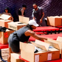 Alicia Fairchild, bottom, helps unbox and unload Beyoncé merchandise before the artists two weekend concerts at NRG Stadium, Saturday, Sept. 23 in...