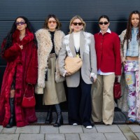 Amaka Hamelijnck wears red faux fur coat, Prada bag, black cropped top, laced skirt, sunglasses, hair band & Michelle Fleur wears beige faux fur...