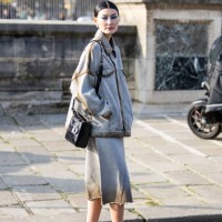 Amalie Gassmann wears grey oversized jacket, skirt, black bag outside Dior during the Womenswear Fall/Winter 2024/2025 as part of Paris Fashion Week...