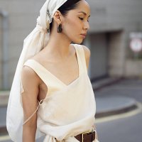 Amalik Baiganisheva wears beige wide pants, brown belt, beige top, beige head scarf during day 1 of Visa Fashion Week Almaty 2025 on May 03, 2025 in...