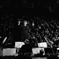 American composer and conductor Leonard Bernstein conducts the New York Philharmonic in front of an audience of children and adults on the set of the...