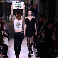 An activist of People for the Ethical Treatment of Animals takes to the catwalk to protest against the use of leather in the fashion industry, as...