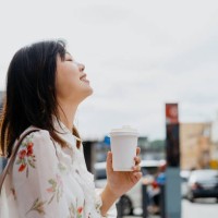an asian chinese woman enjoying coffee on the go - junk food stock pictures, royalty-free photos & images