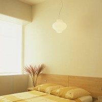 an elegant lamp is suspended from the ceiling above the bed in the bedroom - home decoration stock pictures, royalty-free photos & images