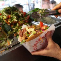 An employee prepares a customer's order at Mustafas Gemüse Kebap on July 06, 2022 in Berlin, Germany. The döner kebab, a fast food sandwich made of...