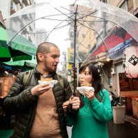 an internationally married couple who came to tsukiji for sightseeing while eating fried food - travel stock pictures, royalty-free photos & images