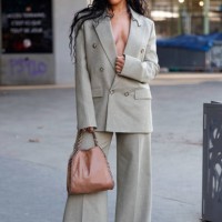 Angel Arutura wears light green suit, brown Stella McCartney bag, outside Stella McCartney, during the Womenswear Fall/Winter 2025/2026 as part of...
