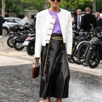 Anna Borisovna is seen wearing a white jacket, purple shirt, black leather skirt, gold belt, brown bag, tan shoes and black sunglasses outside the...