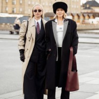 Anna Katinka von der Fehr wears black suit, white shirt red and blue tie, black leather gloves and beige long trench coat and Cathrine Leth Damgaard...