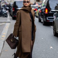 Anna Wein wears brown coat, bag, sunglasses outside Sacai during Womenswear Spring/Summer 2025 as part of Paris Fashion Week on September 30, 2024 in...